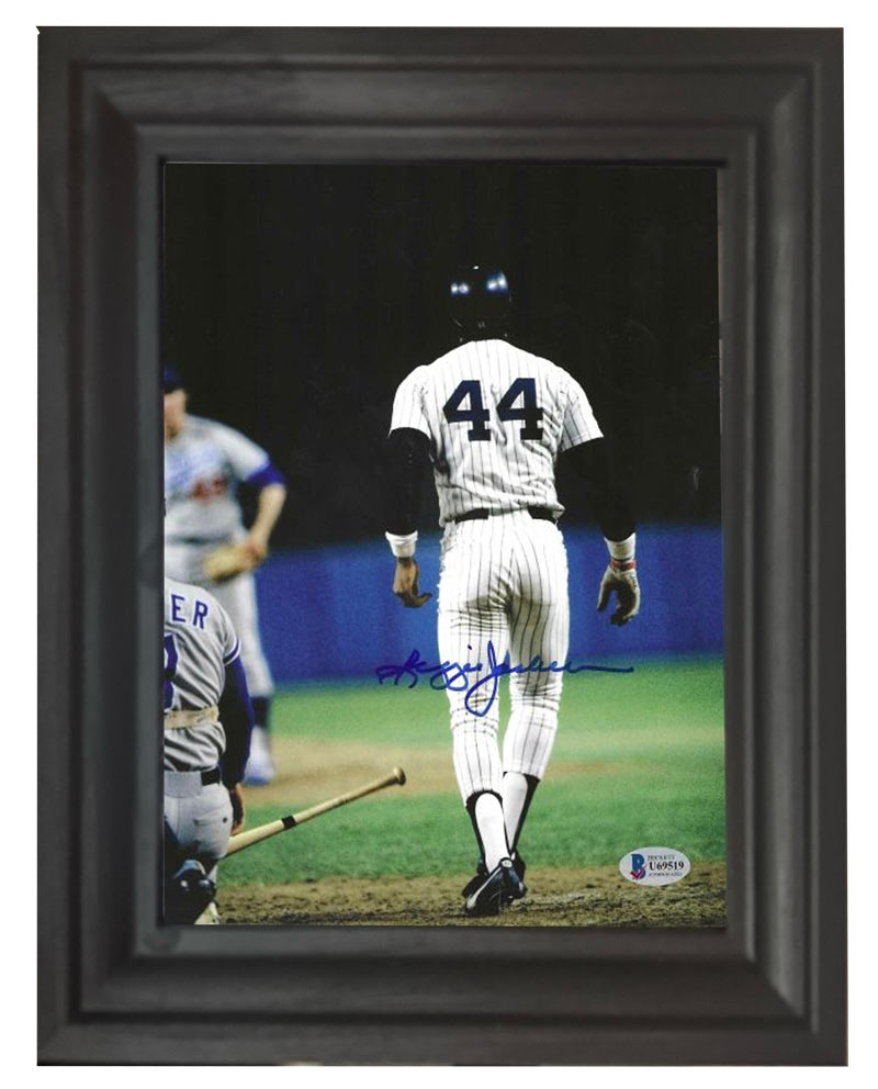 A signed photograph of Reggie Jackson, number 44, walking away from the plate.